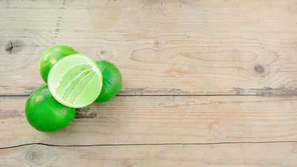 group of green lime on wooden table