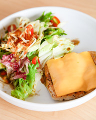 Grilled chicken steak with melted cheese and mixed salad
