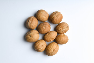 walnuts on a white background. Close up view of walnuts. Walnuts are 4 water, 15 protein, 65 fat and 14 carbohydrates, including 7 dietary fiber. In a reference portion of 100 grams.