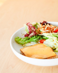 Grilled chicken steak with melted cheese and mixed salad