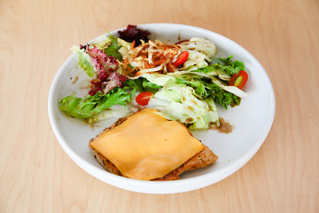Grilled chicken steak with melted cheese and mixed salad