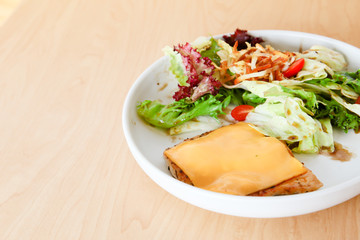 Grilled chicken steak with melted cheese and mixed salad
