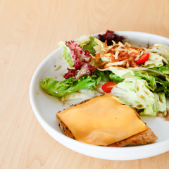 Grilled chicken steak with melted cheese and mixed salad