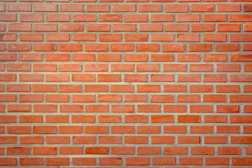 Old Orange brick wall concrete or stone texture background, wallpaper limestone abstract to flooring and homework/Brickwork or stonework clean grid uneven interior rock old. Copy space.