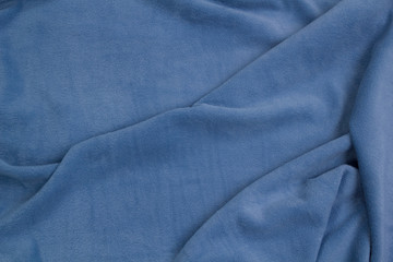 Fototapeta premium Fleece fabric blue top view. Texture of textile fleece bedspread.