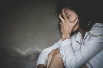 A young woman crying and covering her face. depression or domestic violence. The concept of sexual...