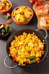 spanish food with paella, tapas and patatas bravas