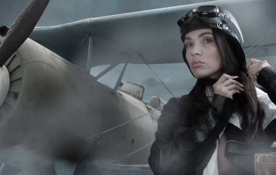 Portrait of a beautiful brunette girl in a retro pilot suit