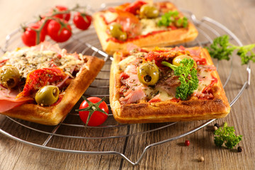 waffle pizza with tomato sauce, olive and cheese