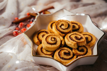  Christmas cinnamon stars on a beautiful plate with decoration and beautiful light - food photography