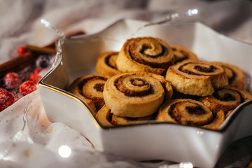 Christmas cinnamon stars on a beautiful plate with decoration and beautiful light - food photography