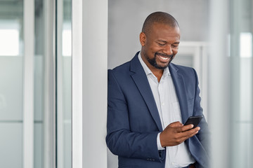 Mature businessman using smartphone