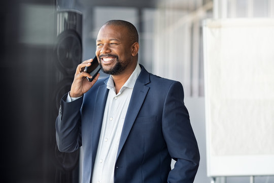 African mature businessman talking over phone