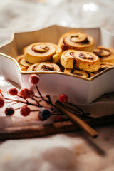  Christmas cinnamon stars on a beautiful plate with decoration and beautiful light - food photography