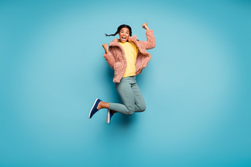 Fototapeta na wymiar Full length body size view of nice attractive lovely overjoyed cheerful cheery girl jumping having fun celebrating isolated on bright vivid shine vibrant green blue turquoise color background