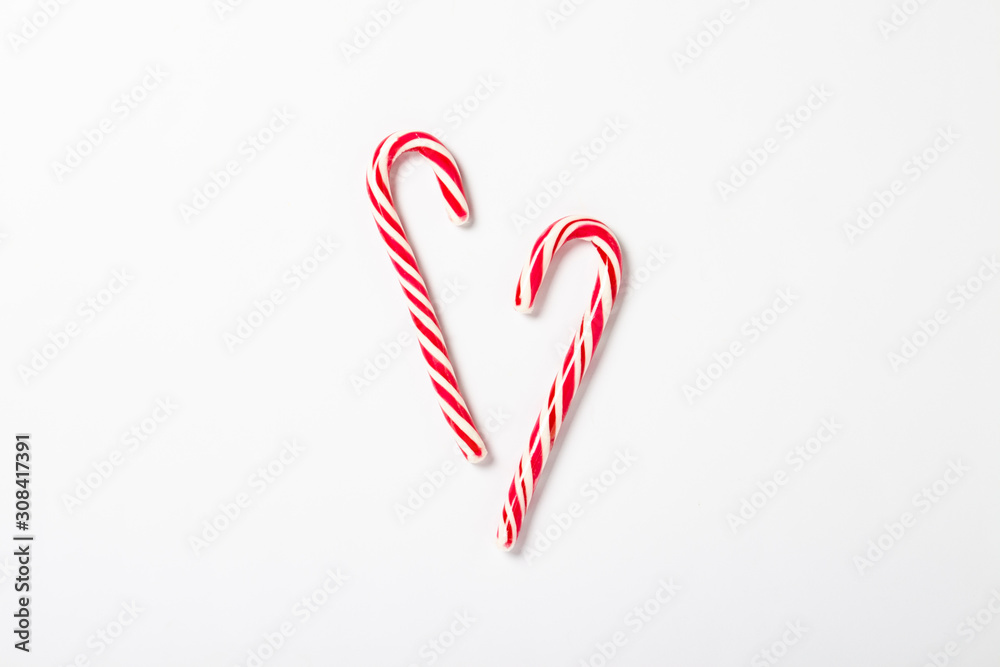 Wall mural Candy caramel cane on a white background. Concept Christmas, New Year, minimalism. Flat lay, top view