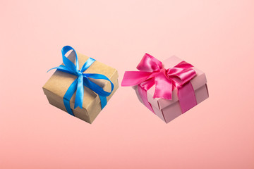 Two gifts flying in the air on a pink background. Concept gift for a loved one, birthday, Valentine's Day. Levitation