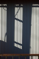 Telephone pole shadow and outer wall 