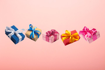 Gifts flying in the air on a pink background. Concept gift for a loved one, birthday, Valentine's Day. Levitation