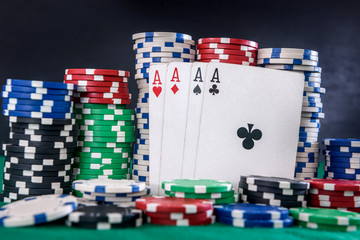 Fototapeta premium Gambling concept. Four aces combination with poker chips on green table