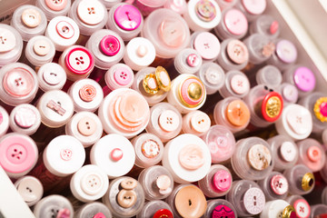 Fototapeta premium Buttons in tubes on store shelves