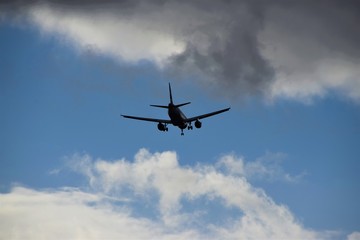 Naklejka na ściany i meble Airplane silhouette high in the sky 