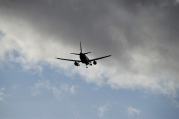 Airplane silhouette high in the sky 