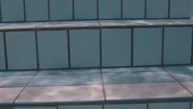 Woman with Flip Flops Walking Up the Staircase in Swimming Pool in Switzerland.