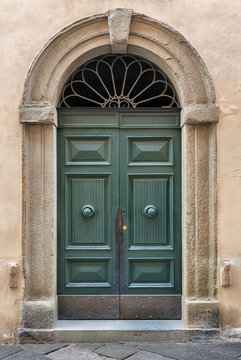 An old decorated vintage door in historical centre of Florence, Italy