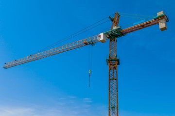Construction site background. Hoisting cranes and new multi-storey buildings. I.ndustrial background.Building construction site work against blue sky