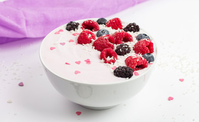 Breakfast smoothie bowl with yogurt, fresh raspberries, blueberries, BlackBerry, coconut flakes and granola. Healthy food. 