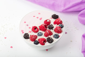 Breakfast smoothie bowl with yogurt, fresh raspberries, blueberries, BlackBerry, coconut flakes and granola. Healthy food. 