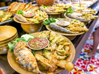Thai food, Shrimp-paste sauce and Tempura vegetables with fried mackerel on shelf for sale in cafeteria.