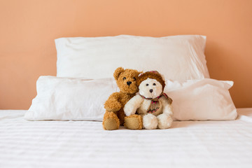 Cute couple brown and white teddy bear sitting together on the bed, bed time, love and romance concept