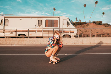 retro style skater girl with a camper van in the background. california lifestyle - obrazy, fototapety, plakaty