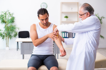 Fototapeta premium Young male patient visiting experienced doctor