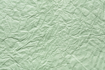 Crumpled paper texture in light green color for your best greeting card.