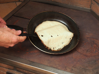 Flipping pancakes with spatula. Making yeast pancakes (crepes).