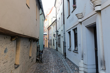 Riga / Latvia - 01 December 2019: Narrow medieval street in old city of Riga, Latvia.