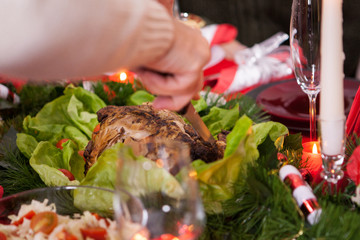 Close up of man hand slicing the chicken for christmas meal