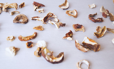 Dried mushrooms on a background of white wood.	