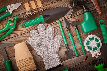 Gardening tools on wooden background flat lay
