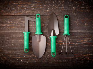 Gardening tools on wooden background flat lay