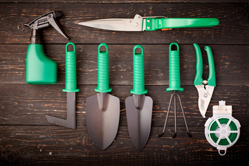 Gardening tools on wooden background flat lay