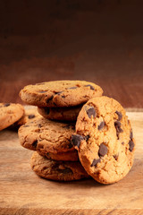 Chocolate chip cookies, gluten-free, a close-up of a stack on a dark rustic background with a place for text
