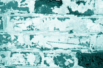 Old grungy brick wall texture in cyan tone.