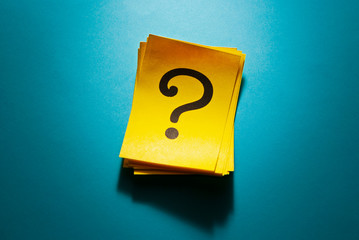 Stack of colorful yellow cards with question mark