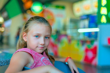 Girl sitting in a cafe in a shopping center