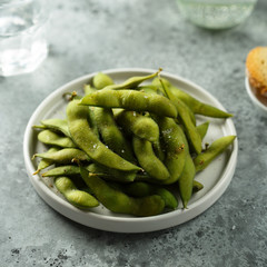 Edamame beans on a white plate