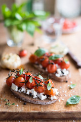 Roasted Cherry Tomatoes with Fresh Cheese on Rye Bread Toast